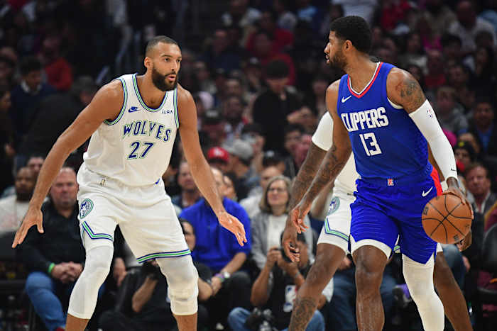Los Angeles Clippers forward Paul George (13) controls the ball against Minnesota Timberwolves center Rudy Gobert (27) during the first half at Crypto.com Arena in Los Angeles on March 12, 2024.